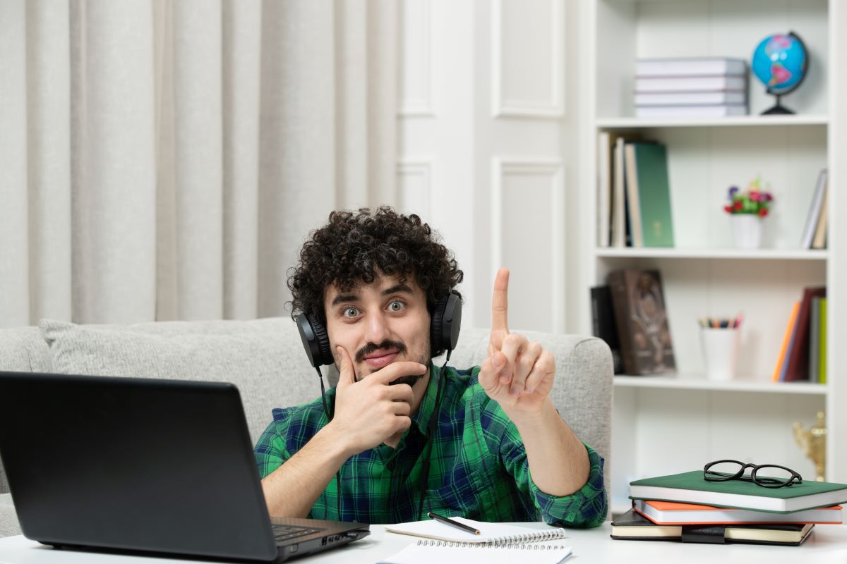 A cute young guy studing computer 